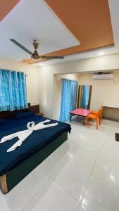 a bedroom with a bed with scissors painted on it at Devka House HomeStay in Daman +26 photos
