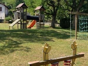 a park with a playground with a slide at Les Chambres de la Closerie in Saint-Didier-sur-Rochefort