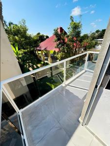 a balcony with a railing on a house at El Amanecer de Chiltepec in Chiltepec