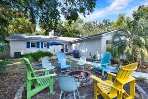 a group of colorful chairs sitting around a fire pit at The Oar House in Tybee Island