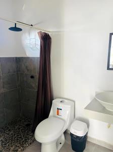 a bathroom with a white toilet and a sink at El Amanecer de Chiltepec in Chiltepec +9 photos