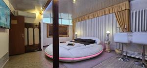 a bedroom with a large white bed in a room at Love Suite vasca idromassaggio in Bologna