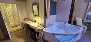 a bathroom with a tub and a sink at Love Suite vasca idromassaggio in Bologna