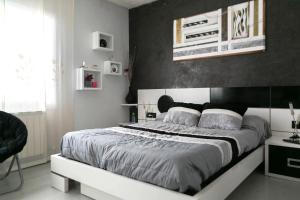 a bedroom with a large bed with a black wall at Villa close to the center w pool garden H30 in Begur