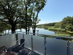 a balcony with a view of a river at Waldhaus Weißwasser in Weißwasser
