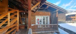 a porch of a log cabin with a window at Gadänäscht in Jenaz +20 photos