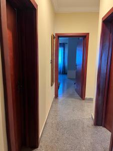 a hallway with two doors and a hallway with a hallway at Adomfie in Accra