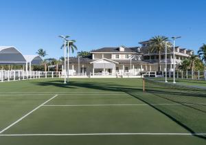 a tennis court in front of a house at The Breakers Palm Beach in Palm Beach +30 photos