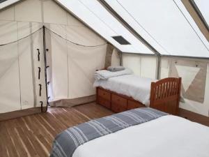 a room with two beds on a boat at North Fork Resort in Greenport