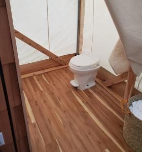 a bathroom with a toilet in a tent at North Fork Resort in Greenport