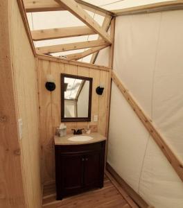 a bathroom with a sink and a mirror at North Fork Resort in Greenport +49 photos