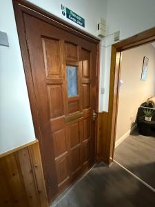 a wooden door in a room with a bed at Vacant Nests Ivy Cottage 3BR Wi-Fi in Banton