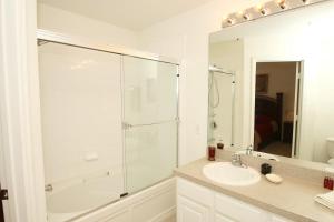 a bathroom with a glass shower and a sink at Windsor Hill Resort Minute to Disney & Theme Parks in Orlando +26 photos