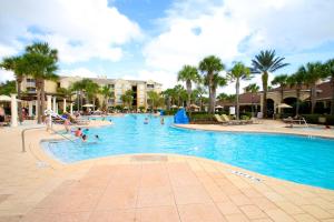 a pool at a resort with people in it at Windsor Hill Resort Minute to Disney & Theme Parks in Orlando