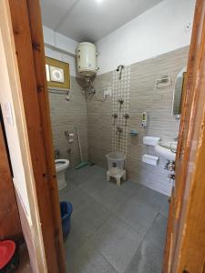 a bathroom with a toilet and a sink at Qpoint hotel in Kasol +33 photos