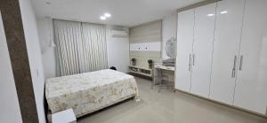 Ένα ή περισσότερα κρεβάτια σε δωμάτιο στο Casa Temporada Gurimar