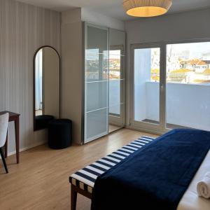 a bedroom with a bed and a table and a mirror at Be Oporto Apartments Clérigos in Porto