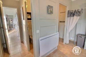 a bathroom with a white door and a toilet at Huna lulu in Pleslin-Trigavou +21 photos