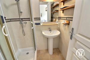 a small bathroom with a shower and a sink at Huna lulu in Pleslin-Trigavou +15 photos
