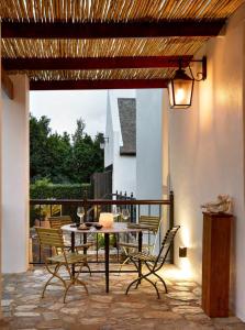 a patio with a table and chairs on a balcony at Ballotina, Tulbagh Cape Wineland in Tulbagh