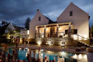a house with a swimming pool in front of it at Ballotina, Tulbagh Cape Wineland in Tulbagh