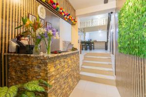 eine Lobby mit Steinmauer und blumengeschmückter Treppe in der Unterkunft Inkary Hotel Machupicchu in Machu Picchu