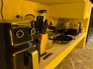 a kitchen counter with a stove and some utensils at rosa house in Medellín