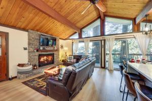 a living room with a couch and a fireplace at 3 Mi to Lake Arrowhead Village Pine-View Home! in Lake Arrowhead