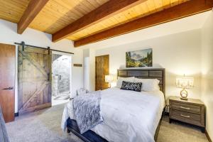 a bedroom with a large bed and a wooden ceiling at 3 Mi to Lake Arrowhead Village Pine-View Home! in Lake Arrowhead