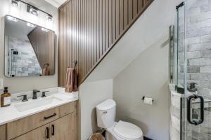 a bathroom with a toilet and a sink and a staircase at 3 Mi to Lake Arrowhead Village Pine-View Home! in Lake Arrowhead +19 photos