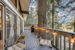 a porch with chairs and a tree with lights at 3 Mi to Lake Arrowhead Village Pine-View Home! in Lake Arrowhead