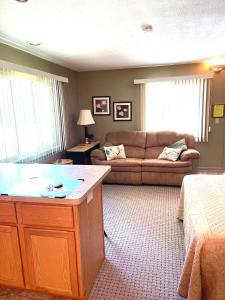 a living room with a couch and a table in it at Schuss #145 Walk to ski hill in Mancelona