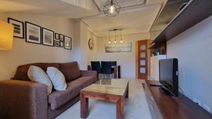 a living room with a couch and a coffee table at Apartamento turístico Aldamar in Llanes