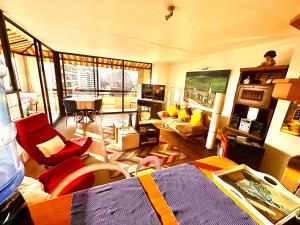 a living room with a couch and a table in a room at sanhatan in Santiago