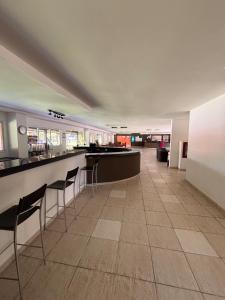 an empty room with a bar with chairs in it at Refúgio em Angra com Praia Privativa in Angra dos Reis