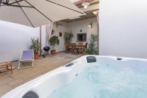 a large bath tub in a yard with a patio at Giardino dellorologio - Salento Reservation in Racale