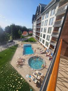 an aerial view of a hotel with a swimming pool at Harmony, Residence Hill A85 in Kopaonik