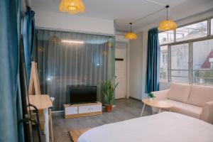 a living room with a bed and a tv at Four Seasons Serenity Studio - SDhousing branch in Hanoi