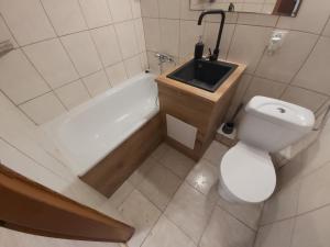a bathroom with a sink and a toilet and a bath tub at 2051 Zwycięstwa 23 - Tanie Pokoje - samodzielne zameldowanie - self check in in Poznań
