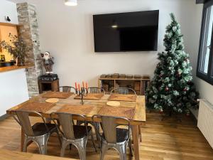 a dining room with a table and a christmas tree at Cedar house in La Charité-sur-Loire