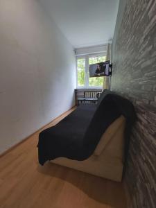 a bedroom with a bed in a brick wall at 2051 Zwycięstwa 23 - Tanie Pokoje - samodzielne zameldowanie - self check in in Poznań