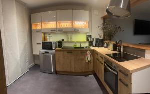 a kitchen with a sink and a stove top oven at Cedar house in La Charité-sur-Loire +11 photos