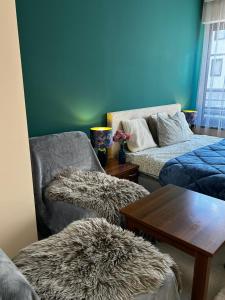 a living room with a couch and a table at Green Point Studio O12 in Chepelare