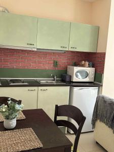 a kitchen with a table and a microwave at Green Point Studio O12 in Chepelare