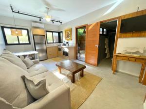a living room with a couch and a table at Casa Mar Villas in Florianópolis