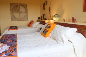 a bedroom with two beds with pillows on them at Casa Bul-Kay's - Where Confort Meets Consierge Care in Chicxulub +70 photos
