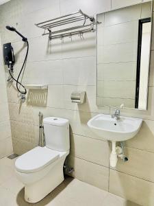 a bathroom with a toilet and a sink at Elite Hotel KL Sentral in Kuala Lumpur