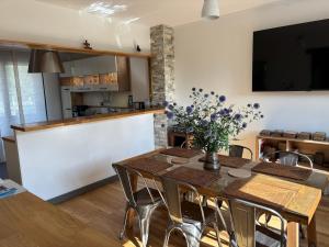 a kitchen and dining room with a table and chairs at Cedar house in La Charité-sur-Loire