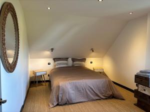 a bedroom with a bed in a attic at Cedar house in La Charité-sur-Loire
