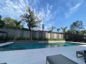 a swimming pool in the middle of a yard at Signature 1 Bedroom at The Bantree Accra in Accra